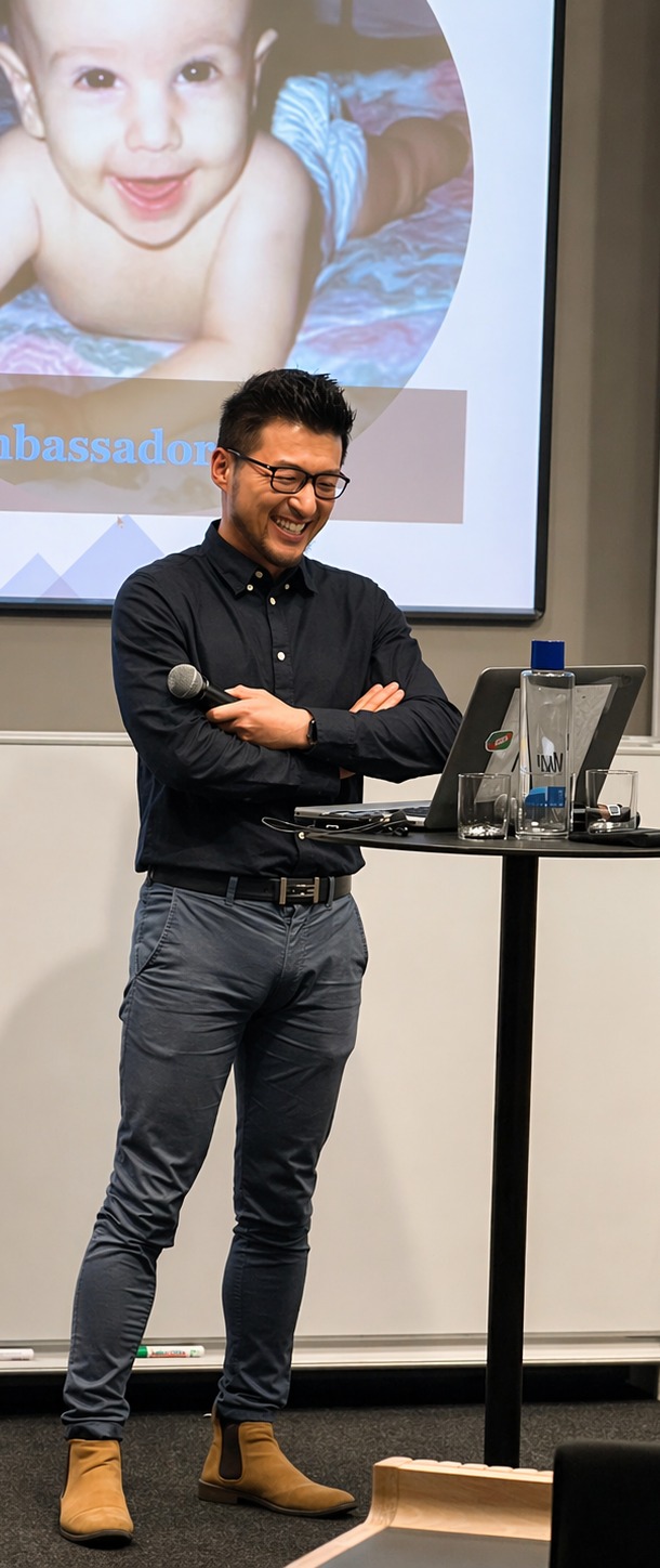Muyi Yang speaking during a public presentation